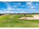 Picturesque golf course featuring sand traps, lush green grass, and a golf cart at 5674 Palmer Circle Dr # 203, Bradenton, FL 34211