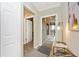 Light-filled hallway featuring neutral tones and access to lanai, and tiled flooring at 5674 Palmer Circle Dr # 203, Bradenton, FL 34211