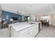 Open concept with a kitchen island, stainless steel sink, and living room combo for entertaining at 5674 Palmer Circle Dr # 203, Bradenton, FL 34211
