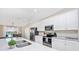 Kitchen with sleek stainless appliances, white cabinets, modern countertop, and an island sink at 5674 Palmer Circle Dr # 203, Bradenton, FL 34211