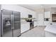Bright kitchen features stainless appliances, white cabinets, and long countertop with modern tiled flooring at 5674 Palmer Circle Dr # 203, Bradenton, FL 34211
