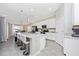 Bright kitchen features a large island with seating and modern stainless appliances at 5674 Palmer Circle Dr # 203, Bradenton, FL 34211