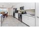 Kitchen with stainless appliances, white cabinets, modern countertop, and adjacent dining room at 5674 Palmer Circle Dr # 203, Bradenton, FL 34211