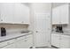 Butler's pantry has white cabinets, modern countertop, under cabinet lighting, and stainless appliances at 5674 Palmer Circle Dr # 203, Bradenton, FL 34211