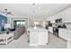 Open concept with a kitchen island, stainless steel sink, and living room combo for entertaining at 5674 Palmer Circle Dr # 203, Bradenton, FL 34211