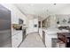 Bright kitchen features stainless appliances, white cabinets, and long countertop with modern tiled flooring at 5674 Palmer Circle Dr # 203, Bradenton, FL 34211