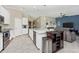 Open concept with a kitchen island, stainless steel sink, and living room combo for entertaining at 5674 Palmer Circle Dr # 203, Bradenton, FL 34211