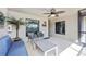 Inviting screened lanai with comfortable seating and ceiling fan offering serene views at 5674 Palmer Circle Dr # 203, Bradenton, FL 34211