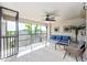 Relaxing screened lanai with comfortable seating and ceiling fan overlooking the lush community at 5674 Palmer Circle Dr # 203, Bradenton, FL 34211