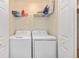 Neat laundry area with full size washer and dryer, and wire shelving for storage at 5674 Palmer Circle Dr # 203, Bradenton, FL 34211