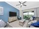 Stylish living room with a large TV and a sliding glass door to the outdoor patio at 5674 Palmer Circle Dr # 203, Bradenton, FL 34211