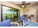 Cozy outdoor patio with comfortable seating overlooking a green space and golf course at 5674 Palmer Circle Dr # 203, Bradenton, FL 34211