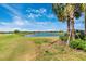 Picturesque pond surrounded by lush green grass and mature trees, perfect for relaxation at 5674 Palmer Circle Dr # 203, Bradenton, FL 34211