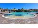 Expansive community pool with sun umbrellas and zero entry at Lakewood National at 5674 Palmer Circle Dr # 203, Bradenton, FL 34211