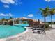 Resort-style pool with a rock waterfall feature and comfortable lounge chairs at 5674 Palmer Circle Dr # 203, Bradenton, FL 34211