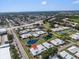 Aerial view of community with beautiful landscaping, water features, and tree lined streets at 57 Sandstone Cir, Venice, FL 34293