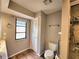 Cozy bathroom with updated fixtures, including a toilet, sink, and walk-in shower at 57 Sandstone Cir, Venice, FL 34293