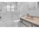 Bathroom featuring a shower and tub combo, single sink vanity, and frosted shower doors at 57 Sandstone Cir, Venice, FL 34293