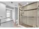 Modern bathroom featuring a glass shower, marble countertop, and ample natural light at 57 Sandstone Cir, Venice, FL 34293