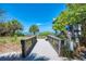 Beach access via wooden bridge leading to lifeguard tower on sunny day at desirable location at 57 Sandstone Cir, Venice, FL 34293