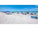 Sandy beach with beach umbrellas and people enjoying the ocean at 57 Sandstone Cir, Venice, FL 34293