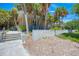 Welcoming entrance to Manasota Beach surrounded by lush palm trees at 57 Sandstone Cir, Venice, FL 34293