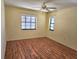 Bright bedroom with wood floors, neutral walls, and two windows at 57 Sandstone Cir, Venice, FL 34293