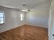This simple bedroom features wood floors, and two windows providing natural light at 57 Sandstone Cir, Venice, FL 34293