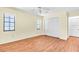 Bright bedroom featuring wood floors, a ceiling fan and double door closet at 57 Sandstone Cir, Venice, FL 34293