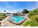 Community pool offers a refreshing escape with lounge chairs, umbrellas, and well-maintained landscaping at 57 Sandstone Cir, Venice, FL 34293