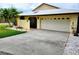 Charming single-story home with a tile roof, attached garage, and well-maintained landscaping at 57 Sandstone Cir, Venice, FL 34293