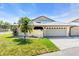 Charming single-story home featuring a well-kept lawn, with a two-car garage at 57 Sandstone Cir, Venice, FL 34293