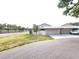 Well-maintained single-story home boasts a two-car garage, neatly landscaped front yard, and inviting curb appeal at 57 Sandstone Cir, Venice, FL 34293