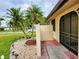 Inviting front entrance with stone landscape and decorative lighting at 57 Sandstone Cir, Venice, FL 34293