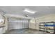 A garage with an automatic door, shelving, and a utility sink at 57 Sandstone Cir, Venice, FL 34293