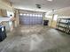 Spacious two car garage with overhead door and room for storage and includes a work bench at 57 Sandstone Cir, Venice, FL 34293