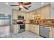 Updated kitchen with stainless steel appliances, granite countertops, and white cabinets at 57 Sandstone Cir, Venice, FL 34293