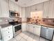 Stainless steel appliances are complemented by granite countertops in this kitchen at 57 Sandstone Cir, Venice, FL 34293