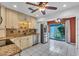 Well-appointed kitchen with stainless appliances and tile floors, adjoining the backyard through glass doors at 57 Sandstone Cir, Venice, FL 34293