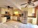 Spacious kitchen with stainless steel appliances, granite countertops, and tile floors at 57 Sandstone Cir, Venice, FL 34293