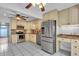 The kitchen includes stainless steel appliances and white cabinets at 57 Sandstone Cir, Venice, FL 34293