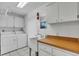 The laundry area features a sink, cabinets, and washer/dryer at 57 Sandstone Cir, Venice, FL 34293