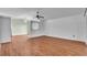 Spacious living room with hardwood floors and a ceiling fan at 57 Sandstone Cir, Venice, FL 34293
