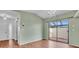 Spacious living room with hardwood floors and large sliding glass doors to the lanai at 57 Sandstone Cir, Venice, FL 34293