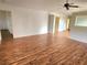 Spacious living room featuring laminate floors, ceiling fan, and ample natural light at 57 Sandstone Cir, Venice, FL 34293