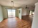 Open-concept living space with hardwood floors and sliding glass doors at 57 Sandstone Cir, Venice, FL 34293