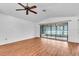 The living room features hardwood floors and sliding glass doors to the enclosed porch at 57 Sandstone Cir, Venice, FL 34293