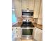 Stainless steel oven with granite countertops and white cabinets at 57 Sandstone Cir, Venice, FL 34293