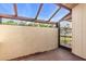 Outdoor patio featuring tiled flooring, partial privacy wall and a metal access gate at 57 Sandstone Cir, Venice, FL 34293
