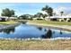 Picturesque pond surrounded by lush greenery and well-maintained landscaping at 57 Sandstone Cir, Venice, FL 34293